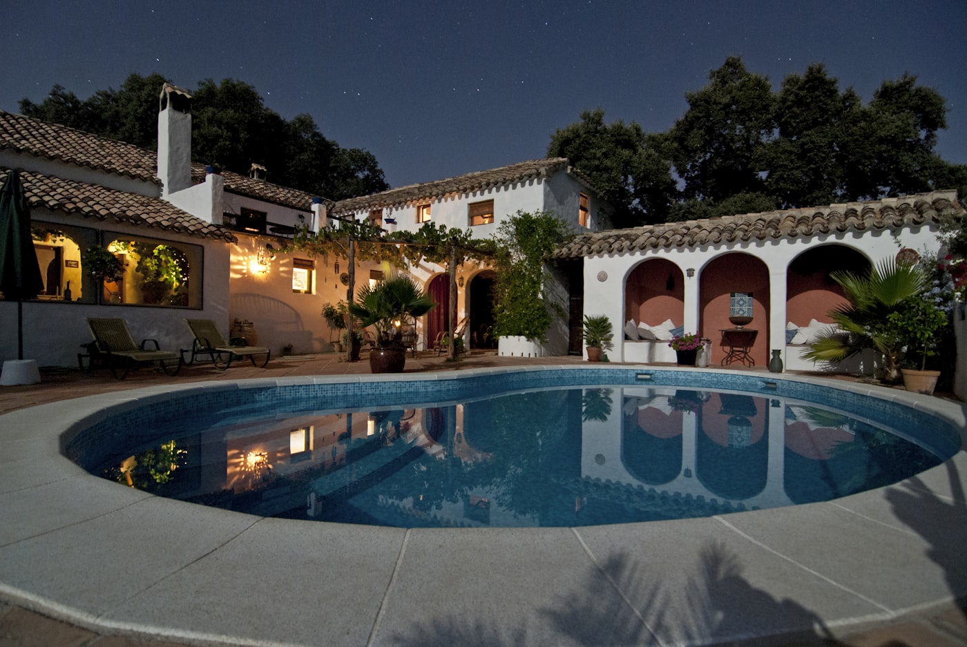 Renovated home exterior and courtyard at dusk