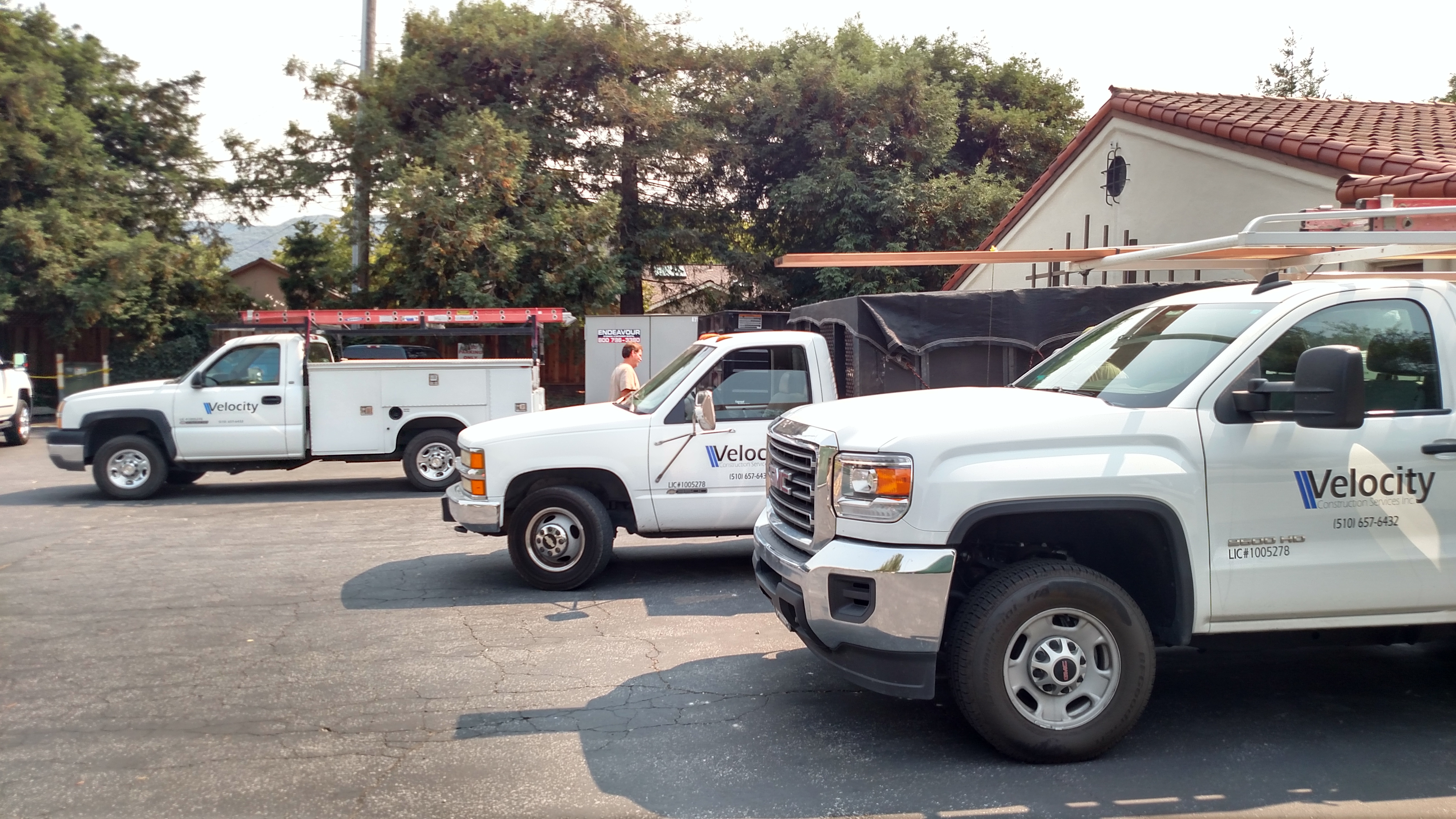 Velocity Construction Services company trucks staged at a Bay Area job site